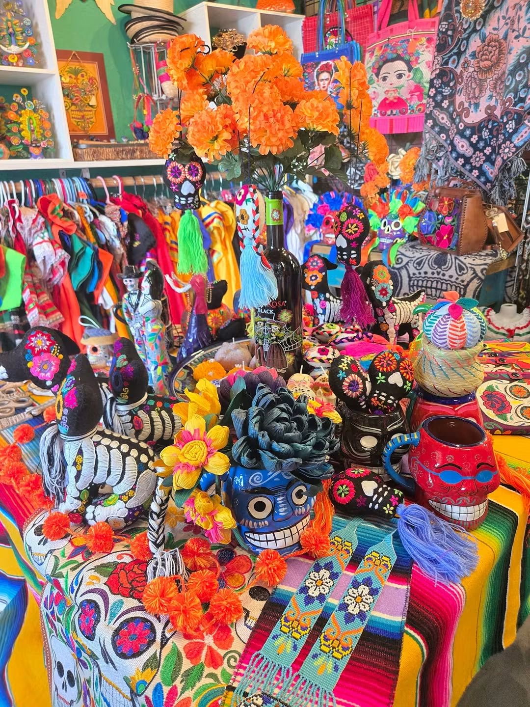 Day of the Dead altar display with marigolds, skulls and textiles