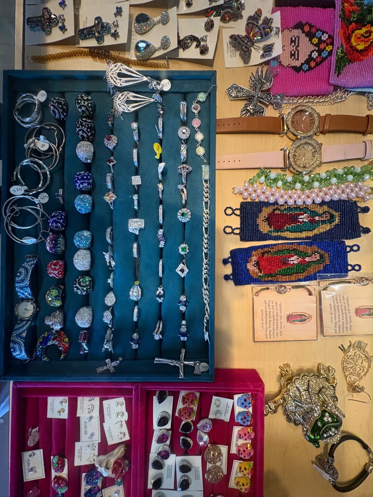 Jewelry display of rings, watches, bracelets and Guadalupe beadwork