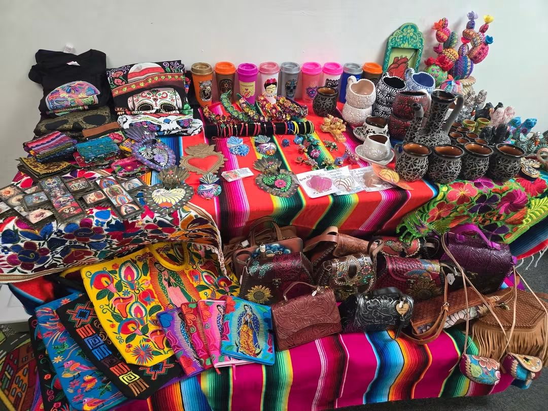 Festival table display of serapes, bags, mugs and folk art