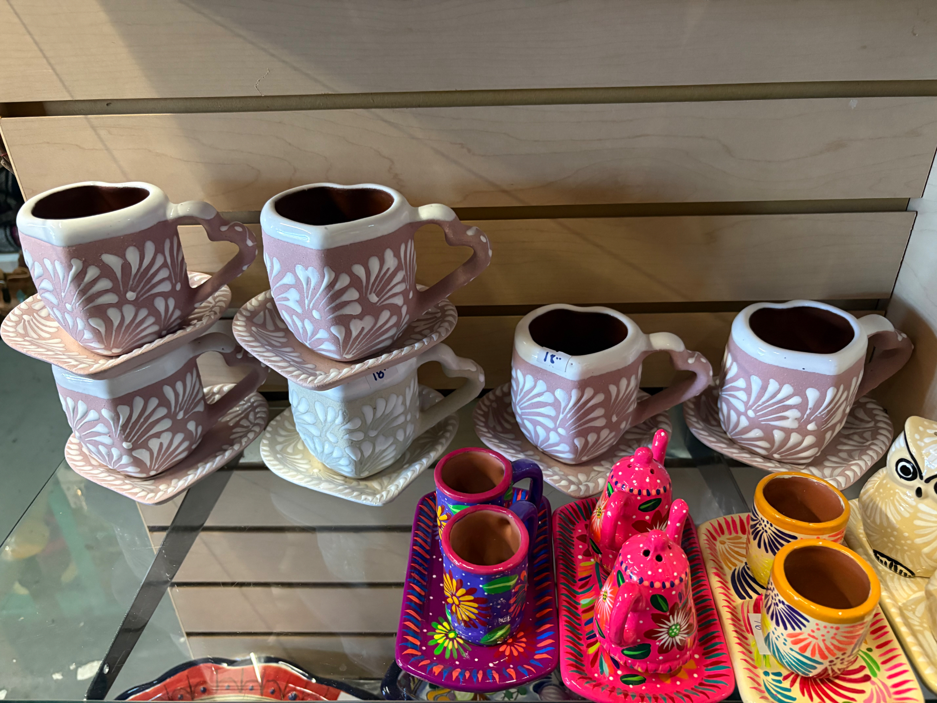 Stacked Mexican ceramic mugs, plates and decorative pieces