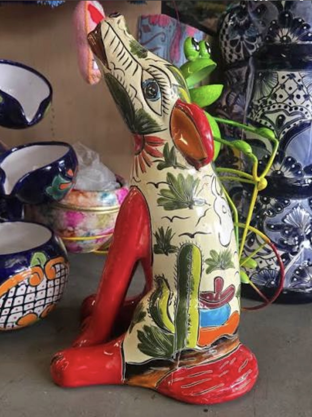 Hand-painted ceramic rabbit sculpture with cactus and floral motifs